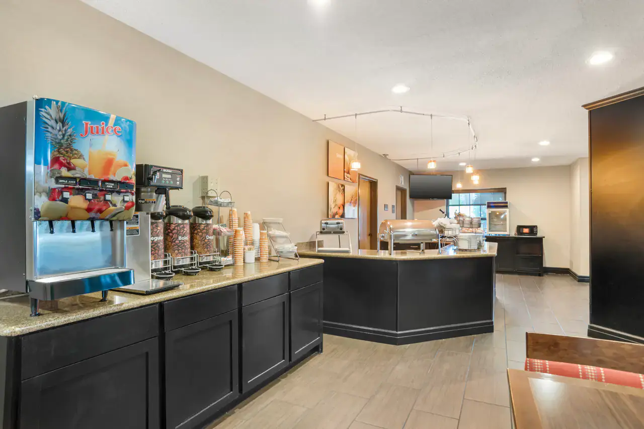 Hot breakfast buffet at Comfort Suites Monroe with juice, coffee, and fresh dining seating
