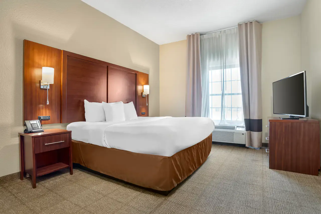 King bed in a one-bedroom suite at Comfort Suites Monroe